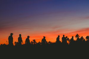 men walking at sunset