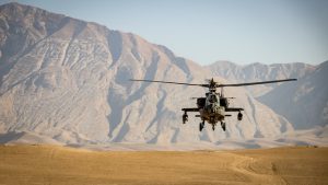 helicopter flying over desert